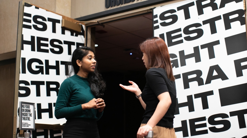 Students talking outside of a theatre