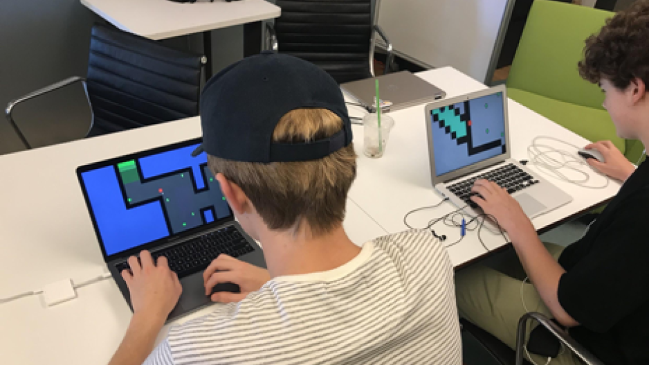 High School Students Designing Games on Laptops