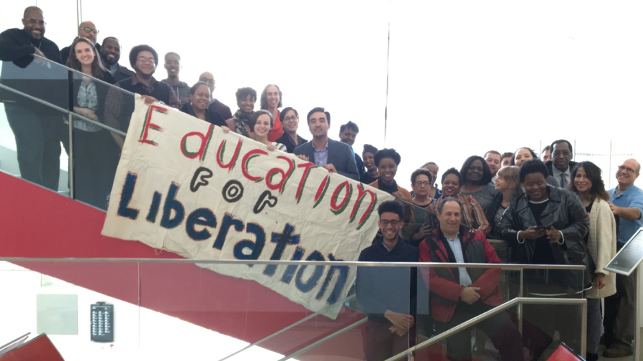 People holding banner with the text "education for liberation"