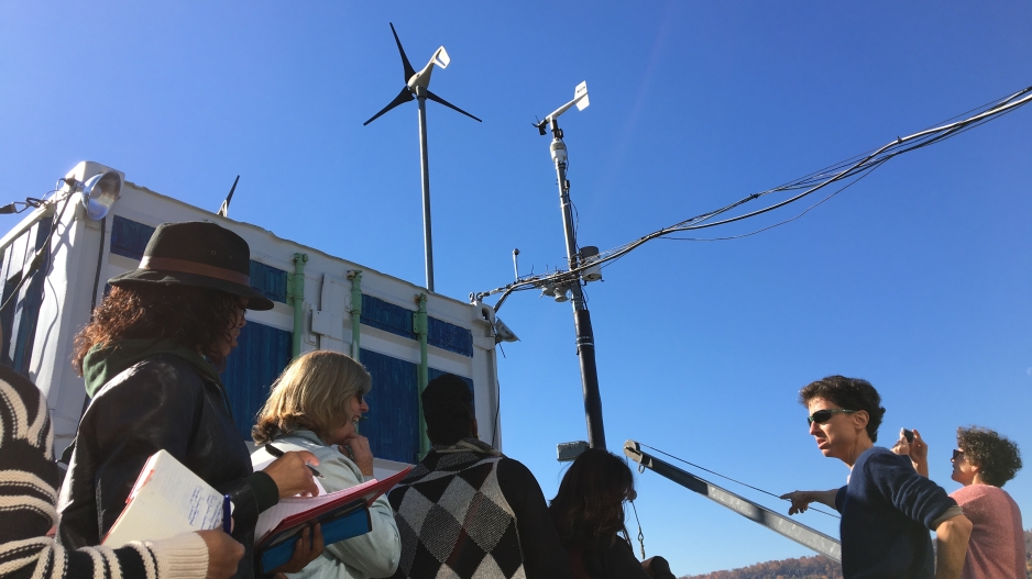 Image of educators with small wind turbines in the background