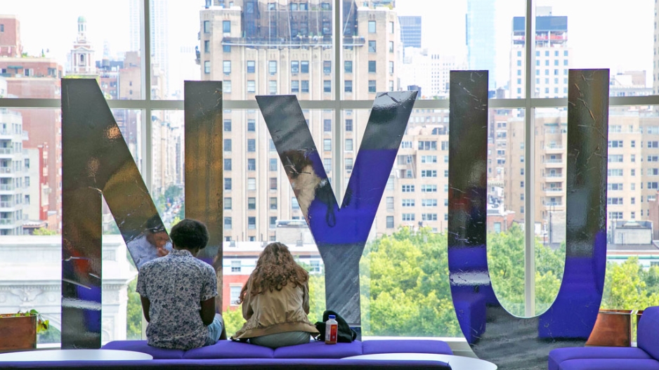 Two students study in the Kimmel Center for University Life overlooking Washington Square