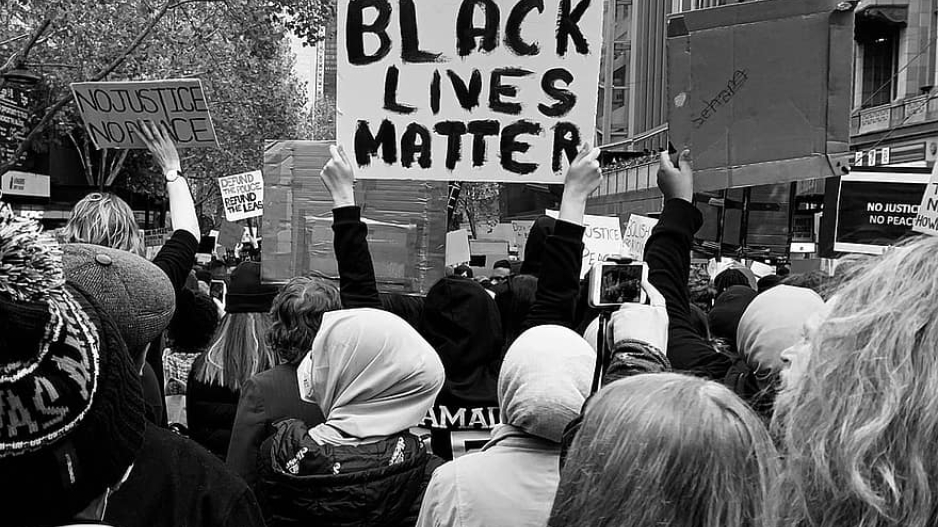 Protestors holding Black lives matter placard-street