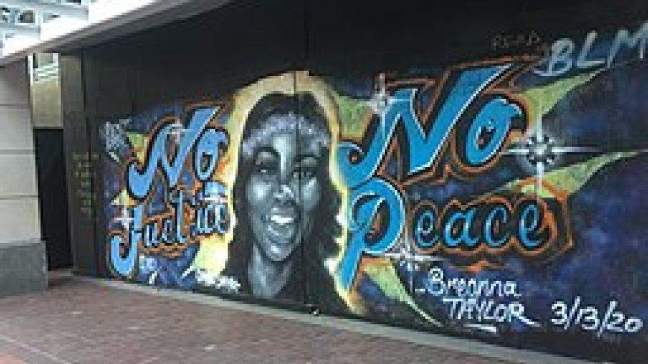 A memorial mural of Breonna Taylor with the words no justice no peace