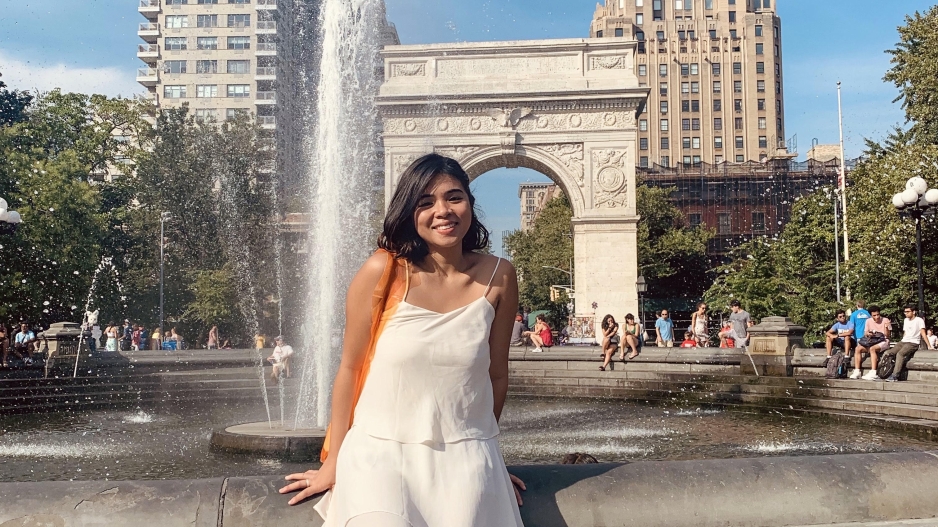 Precious in front of the Washington Square Park fountain and arch