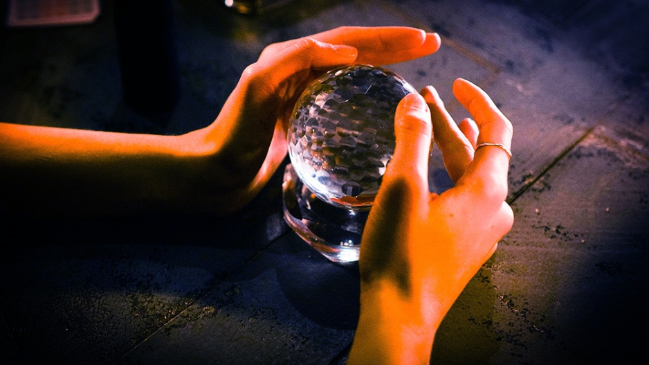 Hands around a crystal ball