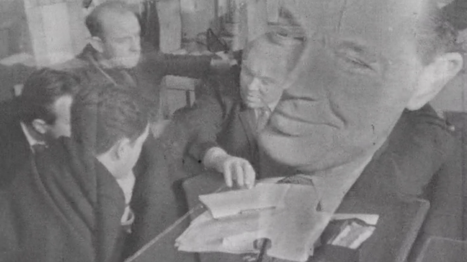 Screenshot from "The Chronicles of Izhor" showing a man's face superimposed over a group of men meeting