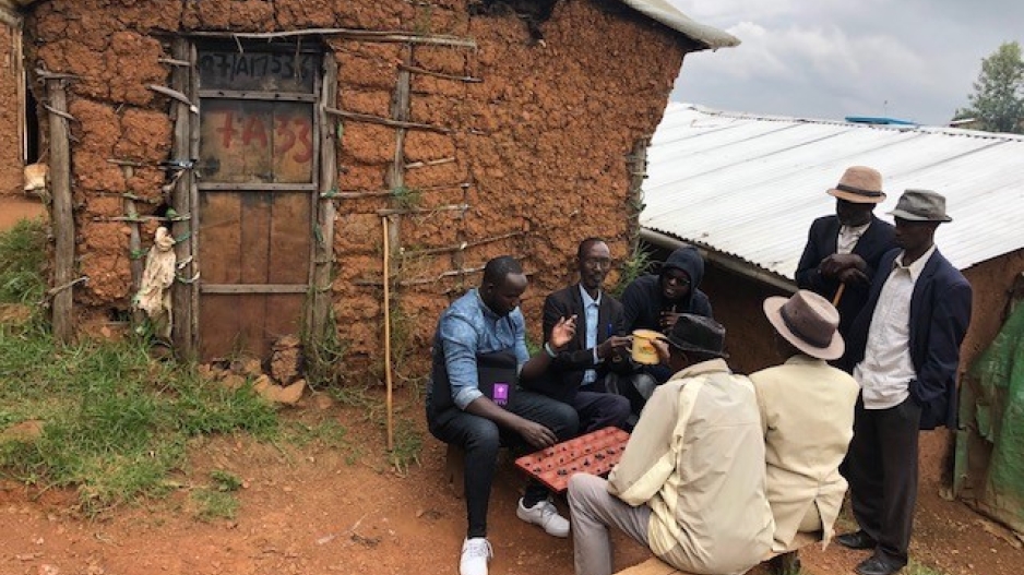 Mondiant Dogon sitting and talking with elders in Gihembe
