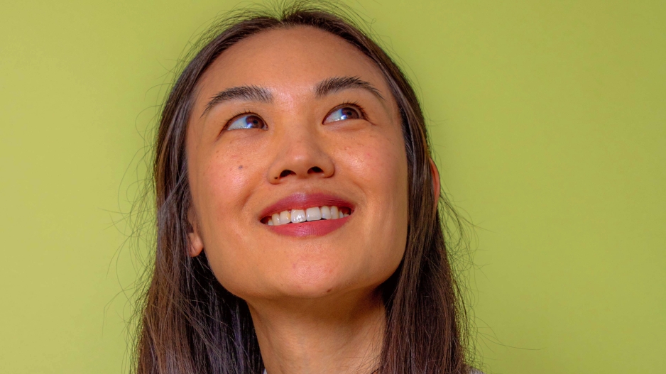 woman smiling, green background
