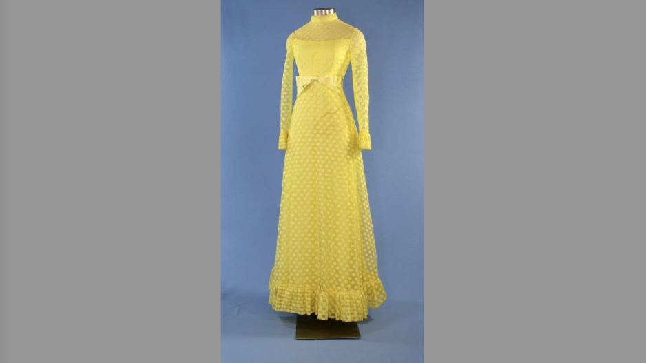 lemon-yellow chiffon gown with high neck.