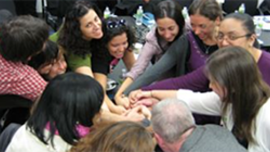 Group of people in circle holding hands