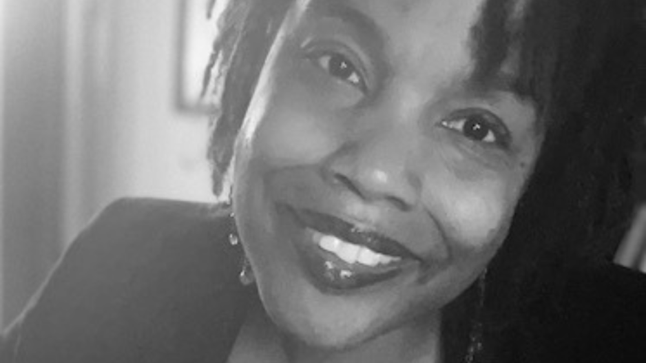 Dr. Andolyn Brown smiles in a black and white photo