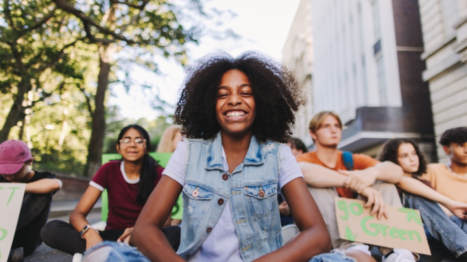 black girl smiling with group of teenagers