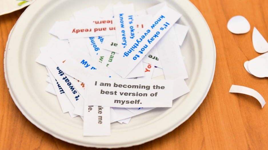 A paper plate full of slips of paper, on which are printed various affirmations such as "I am becoming the best version of myself."