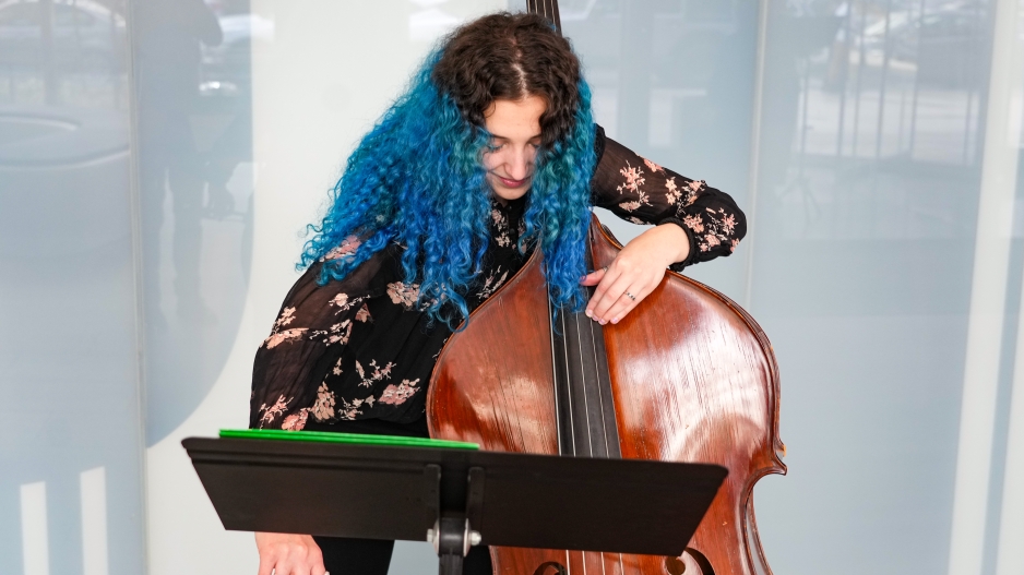 NYU student playing the cello at paulson center