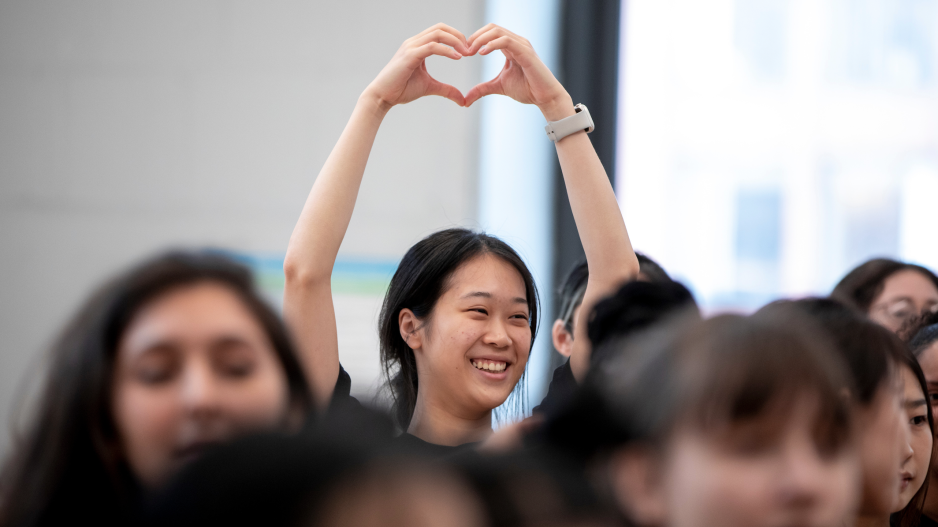 NYU student making a heart with her hands