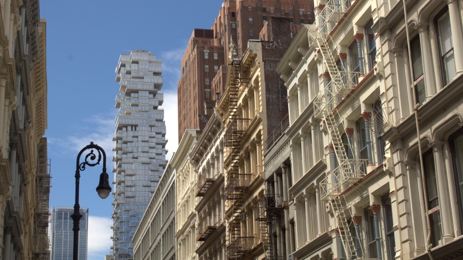 Photograph of the Jenga building (slightly to the left of the picture) in Manhattan from the viewpoint of a street in Soho. 