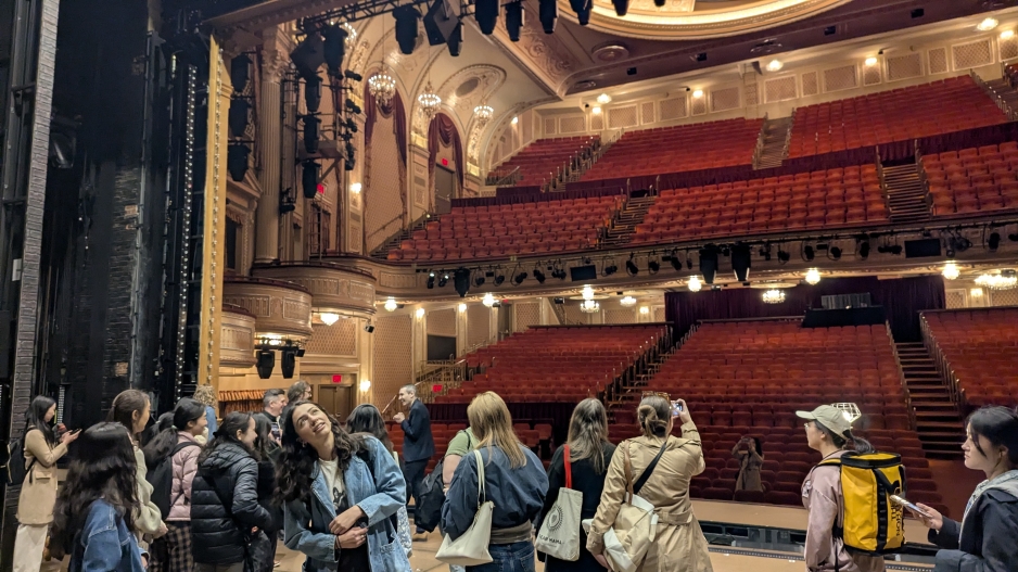 Students are looking around the theatre facility from the stage