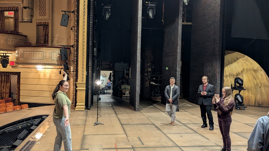 Students are taking turns taking pictures on the stage of the Majestic Theater
