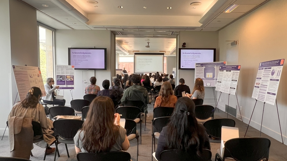 Participants at CoHRR's 2025 showcase seated in chairs watching director Adam Buchwald introduce the 