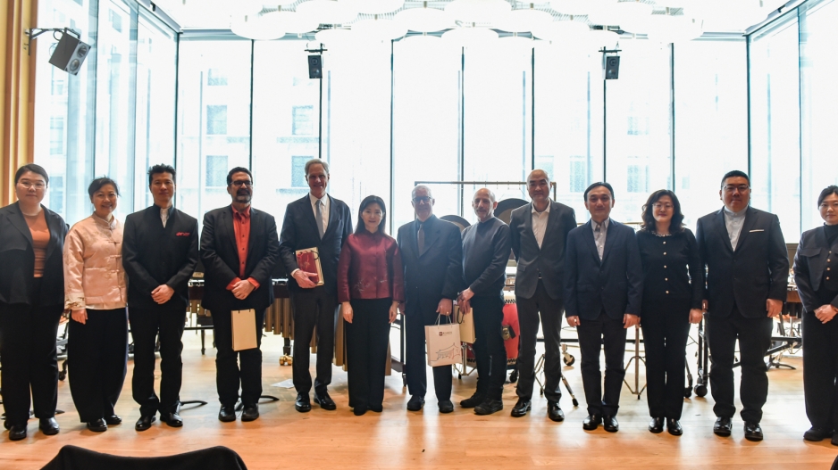 Large group of people standing in brightly lit Paulson Center posing for photo