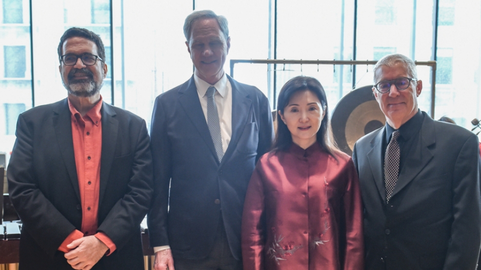 Four people standing for a posed photo