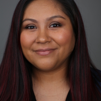 Image of Dr. Erica Saldivar Garcia wearing a black shirt and navy blazer. 