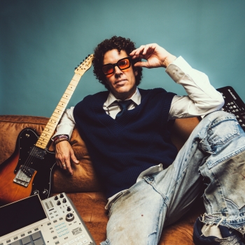 MrSonic sitting on couch surrounded by music instruments