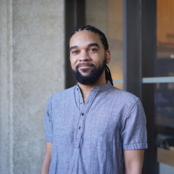 Person looking at camera, soft smile, visible from their waist up