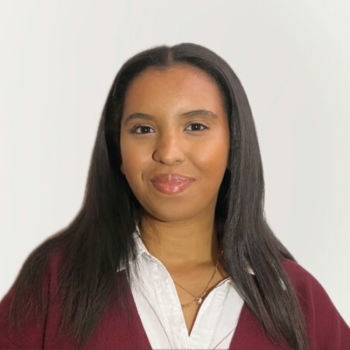 Headshot of Selam Feleke, wearing red and white 