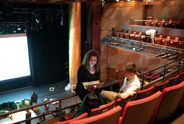 Students in the Skirball Theater with a laptop