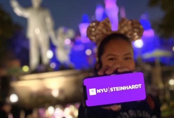 Admitted student celebrating by flashing NYU Steinhardt on her phone