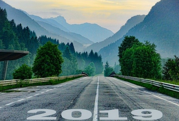 A road with 2019 written on it leads into a mountain landscape
