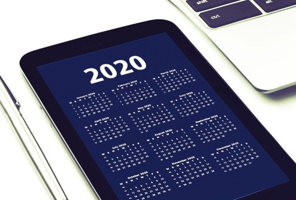 A tablet showing a screen with the header "2020" followed by a monthly calendar for the year. 