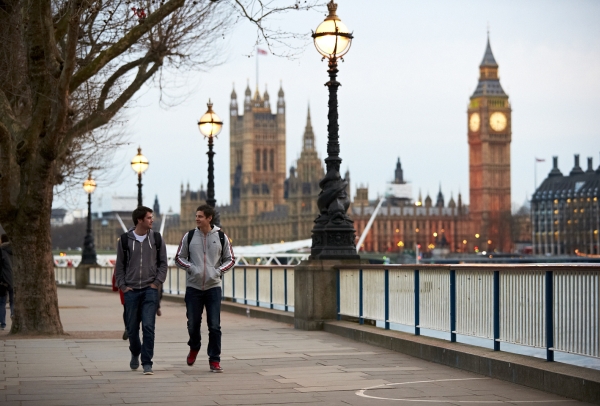 An image of NYU student walking down The Queen's Walk by River Thames with Big Ben in the background. 