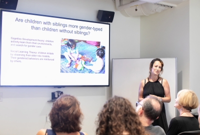 Woman presenting powerpoint in front of group