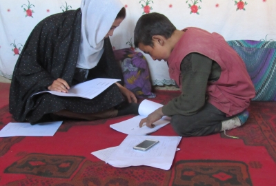 A teacher helping a child with schoolwork