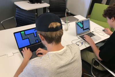 High School Students Designing Games on Laptops