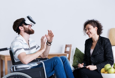 Man in wheelchair with virtual reality headset
