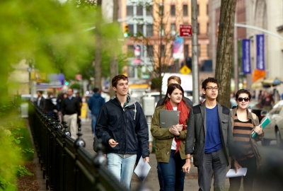 A group of undergrad students walk along Washington Square North