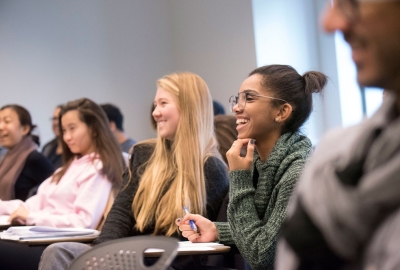 A diverse group of students enjoying a classroom lecture