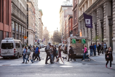 A crowded crosswalk on Washington Place and Broadway