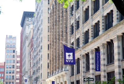 NYU and NYU Steinhardt banners hanging outside campus building
