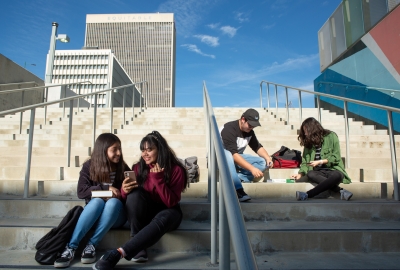 High school students gather on the stairs between classes. 