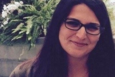 woman with glasses smiling