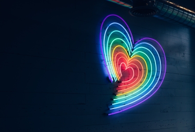 A heart shaped LED light made up of rainbow colors