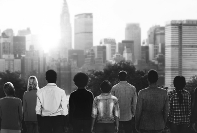 Black and white photo of people looking at the skyline.