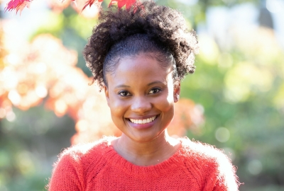 headshot photo of Shari-Lee Carter, smiling and wearing a red sweater