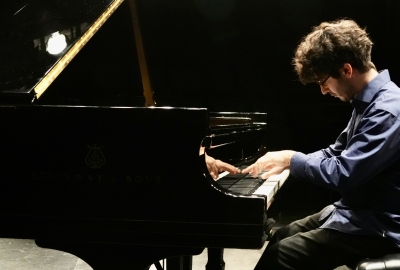 NYU student playing Steinway grand piano
