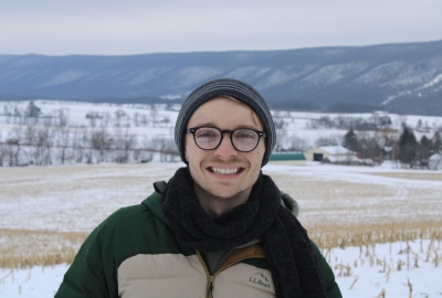 Photo of Anthony during the winter season, snow and mountains in background