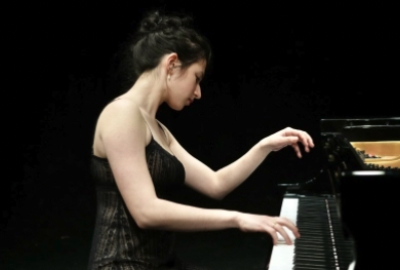 NYU female student gracefully playing piano